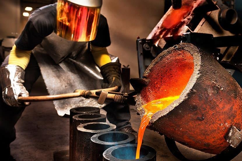 worker pouring molten steel into crucibles in a foundry 1 3 2